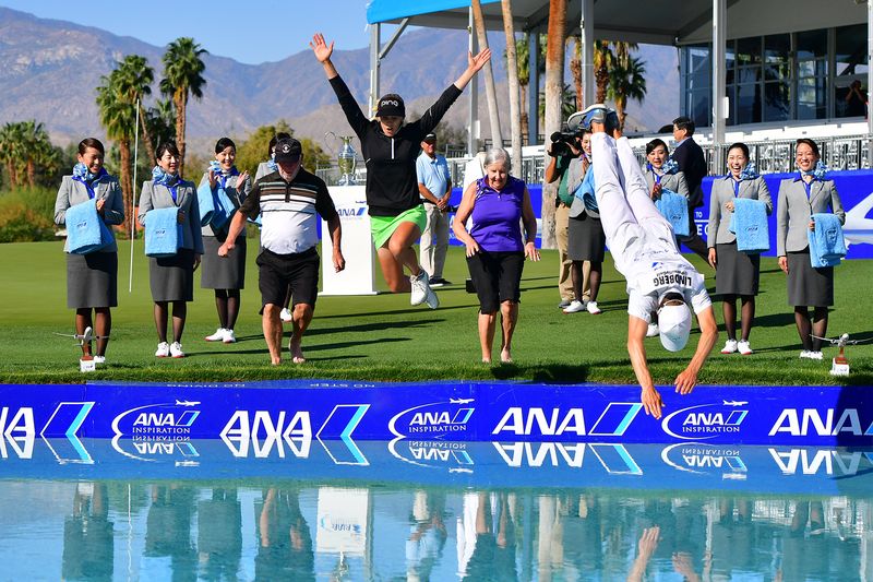 Pernilla Lindberg leaps into Poppie’s Pond as spectators cheer